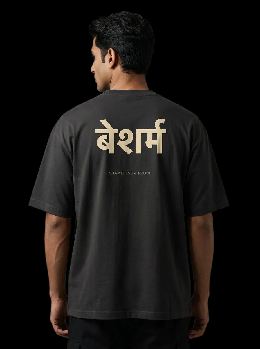 Person wearing a black t-shirt with gold text on the back against a gray background